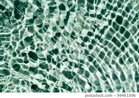 Rippled transparent fresh green water gel surface in swimming pool with flecks, waves. Relaxation. Copy space background Rippled transparent fresh green water gel surface in swimming pool with flecks, waves. Relaxation. Copy space background 99461896