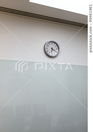 clock on wall of empty office 99461961