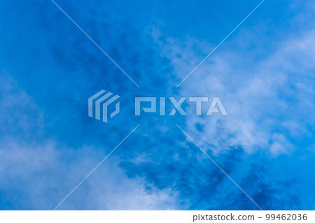 A drawn blue sky with fluffy soft white clouds of natural weather wind background 99462036