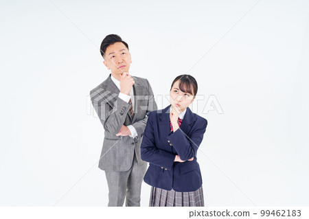 A man and a high school girl in a suit with an uneasy expression A man and a high school girl in a suit with an uneasy expression 99462183