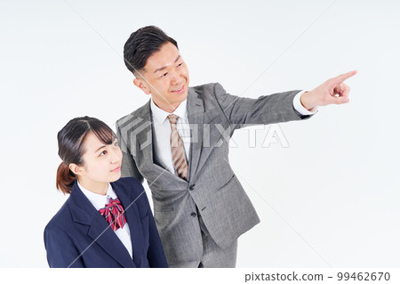 A man and a high school girl in a suit pointing up A man and a high school girl in a suit pointing up 99462670