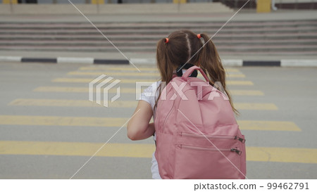child with backpack crosses road pedestrian crossing. running child pedestrian crossing sign. zebra road near school. cars let child running school for lesson class. running child bag school concept child with backpack crosses road pedestrian crossing. running child pedestrian crossing sign. zebra road near school. cars let child running school for lesson class. running child bag school concept 99462791