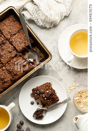 Top view, vegan brownies with chocolate chips and rolled oats in square baking tray. Top view, vegan brownies with chocolate chips and rolled oats in square baking tray. 99463079
