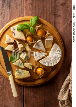 Top view cheese board with blue cheese, cheddar and fruit cheese. Wooden background 99463080