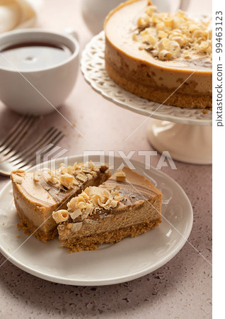 Caramel cheesecake slices and served with cup of tea Caramel cheesecake slices and served with cup of tea 99463123