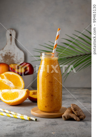 Orange smoothie made with peach, ginger and orange, healthy drink. Orange smoothie made with peach, ginger and orange, healthy drink. 99463130