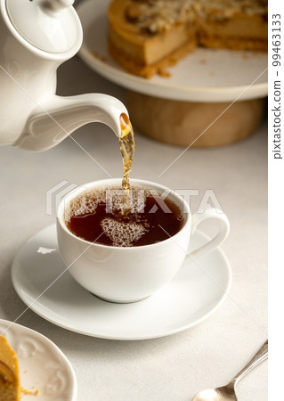 Tea service on a white table : Iron kettle, tea cup with hot tea, a soup  bowl & special spoon. Beautiful typical chinese restaurant Stock Photo -  Alamy