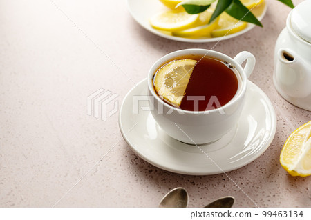 White cup of black tea and lemon slice. Drinking tea, copy space. White cup of black tea and lemon slice. Drinking tea, copy space. 99463134