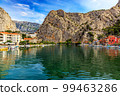 Croatia, City of Omis, a popular tourist destination for trekking and rafting on the Cetina river. Mountains, river, pleasure boats. 99463286