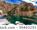 Croatia, City of Omis, a popular tourist destination for trekking and rafting on the Cetina river. Mountains, river, pleasure boats. 99463293