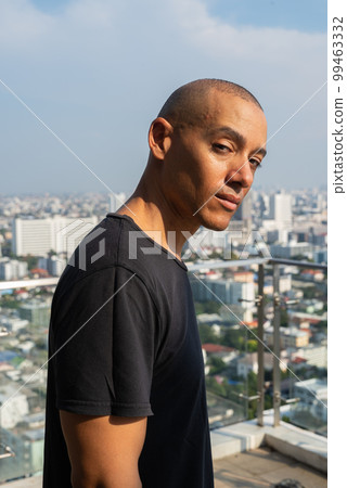 Portrait of handsome bald man wearing t-shirt outdoors Portrait of handsome bald man wearing t-shirt outdoors 99463332