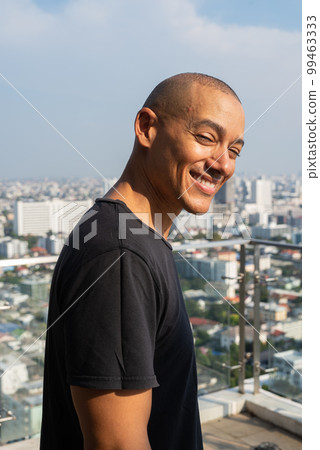 Portrait of handsome bald man wearing t-shirt outdoors Portrait of handsome bald man wearing t-shirt outdoors 99463333