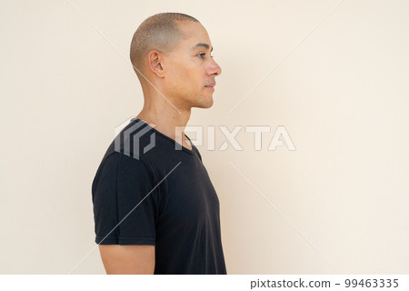 Profile view portrait of handsome bald man wearing t-shirt Profile view portrait of handsome bald man wearing t-shirt 99463335