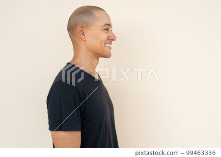 Profile view portrait of handsome bald man wearing t-shirt Profile view portrait of handsome bald man wearing t-shirt 99463336
