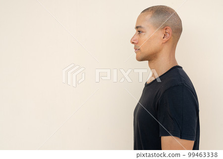 Profile view portrait of handsome bald man wearing t-shirt Profile view portrait of handsome bald man wearing t-shirt 99463338
