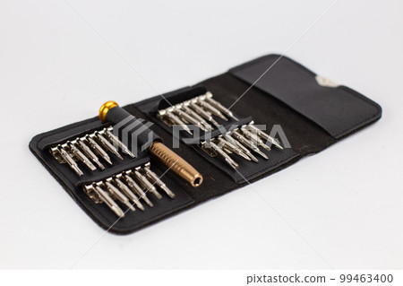 a set of screwdrivers in a leather case on a white background 99463400