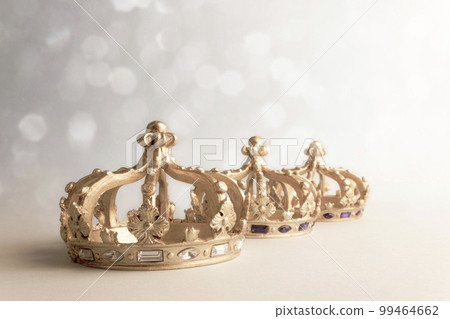 Three golden color crowns on light background. Concept for Reyes Magos, Three Wise Men or Happy Epiphany day. 99464662