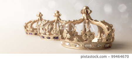 Three golden color crowns on light background. Concept for Reyes Magos, Three Wise Men or Happy Epiphany day. Three golden color crowns on light background. Concept for Reyes Magos, Three Wise Men or Happy Epiphany day. 99464670
