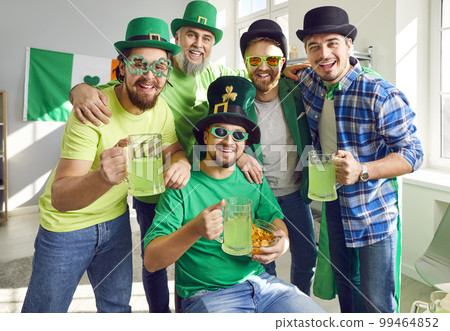 Group portrait of happy male friends with green beer at Saint Patrick's Day party Group portrait of happy male friends with green beer at Saint Patrick's Day party 99464852