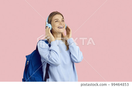 Happy girl student listen to music in earphones Happy girl student listen to music in earphones 99464853