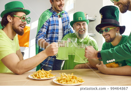 Group of happy men celebrating Patrick's Day, drinking green beer, and having fun 99464867
