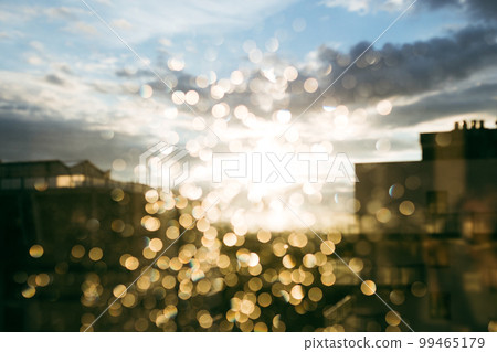 Rain drops texture on window glass. Sunset light abstract blurred cityscape bokeh background Rain drops texture on window glass. Sunset light abstract blurred cityscape bokeh background 99465179