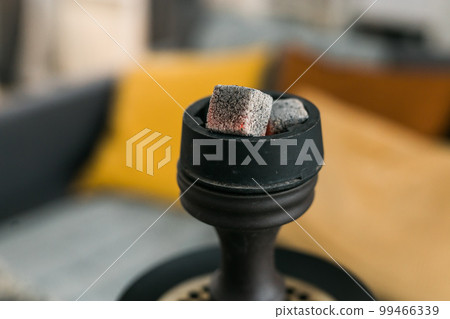 Hookah shisha with glass flask and metal bowl in room background copy space and empty place for text. Traditional Eastern vacation for relaxation 99466339