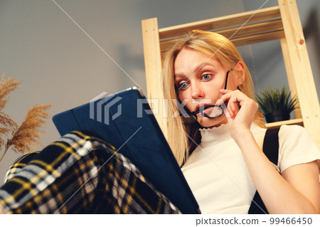 Woman at night home surfing on internet with digital tablet. Stay at Home. Woman at night home surfing on internet with digital tablet. Stay at Home. 99466450