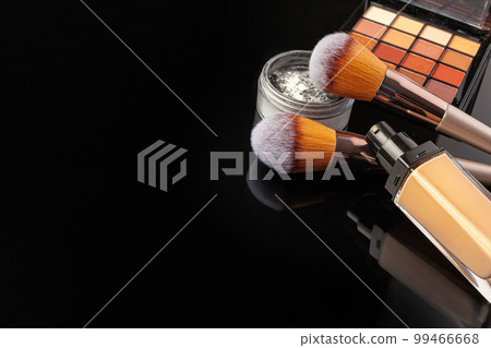Professional makeup brushes and tools, make-up products set on dark table 99466668