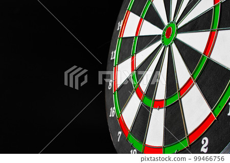 Dartboard on black dark background close up 99466756