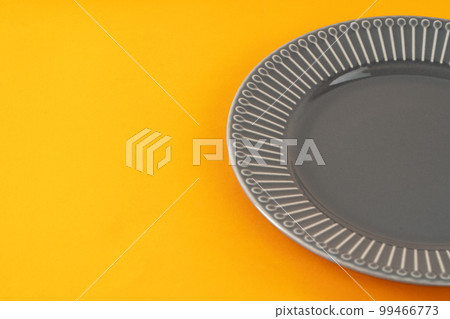Glossy new ceramic dishware on paper background Glossy new ceramic dishware on paper background 99466773