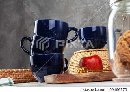 Still life photo of empty tea cup with honey spoon 99466775