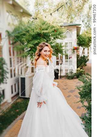 rear view. the bride walks through the garden. rear view. the bride walks through the garden. 99467350