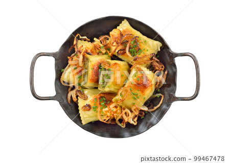 Fried Swabian meat ravioli (so called Maultaschen) with roasted onions, served in an iron frying pan Fried Swabian meat ravioli (so called Maultaschen) with roasted onions, served in an iron frying pan 99467478