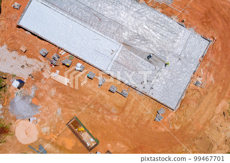 Polyethylene is laid down as waterproofing layer before concrete is poured into foundation Polyethylene is laid down as waterproofing layer before concrete is poured into foundation 99467701