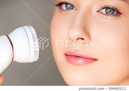 Anti-aging cosmetology and beauty treatment product, woman using face exfoliation massage roller device as cosmetic procedure and skincare routine, close-up Anti-aging cosmetology and beauty treatment product, woman using face exfoliation massage roller device as cosmetic procedure and skincare routine, close-up 99468521