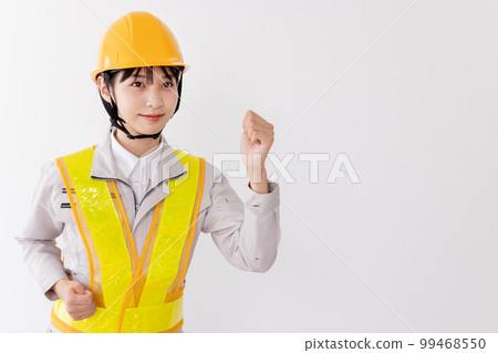 Motivated worker wearing a reflective vest 99468550