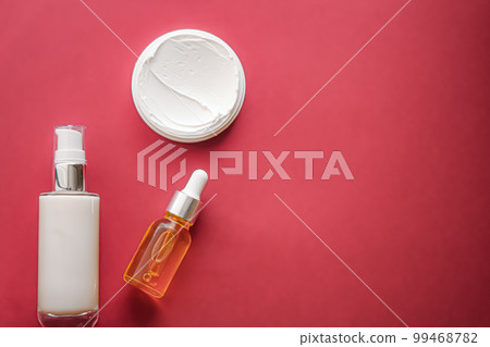 Skincare cosmetics and anti-aging beauty products, luxury skin care bottles, oil, serum and face cream on coral background. Skincare cosmetics and anti-aging beauty products, luxury skin care bottles, oil, serum and face cream on coral background. 99468782
