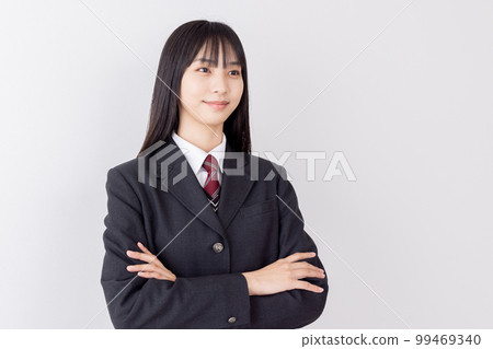 A high school girl with her arms crossed and a confident face A high school girl with her arms crossed and a confident face 99469340