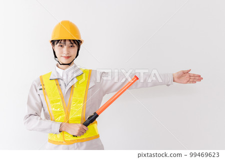 A security guard wearing a reflective vest to guide A security guard wearing a reflective vest to guide 99469623