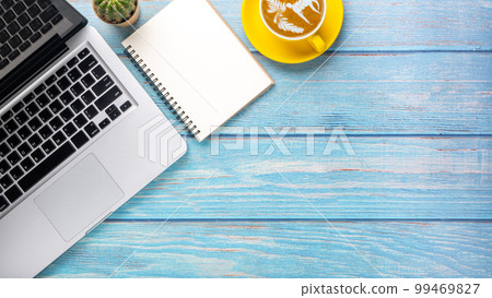 Woodesk desk workplace with laptop computer, notebook and cup of coffee, Top view flat lay with copy space. Woodesk desk workplace with laptop computer, notebook and cup of coffee, Top view flat lay with copy space. 99469827