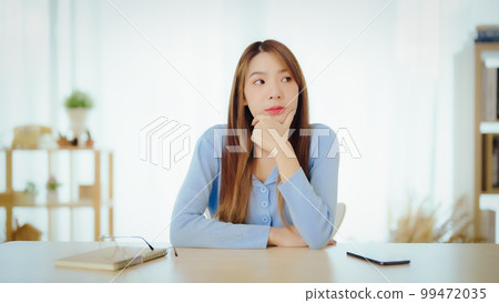 Distracted from work worried young asian woman thinking of problems 99472035