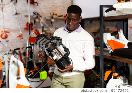 African-american man choosing drainline pump 99472401