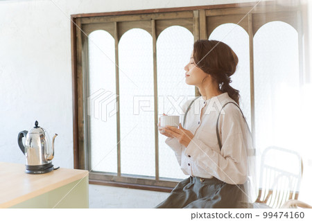 Photo of a woman drinking tea 99474160