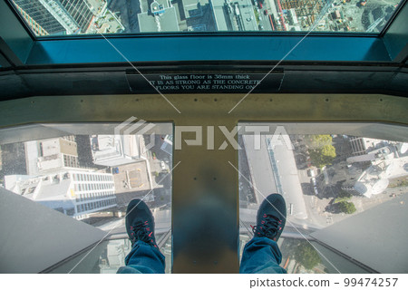 Auckland view on below of glass floor from Auckland Sky Tower observation desk, New Zealand. Auckland view on below of glass floor from Auckland Sky Tower observation desk, New Zealand. 99474257
