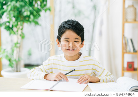 A boy studying in the living room 99474904