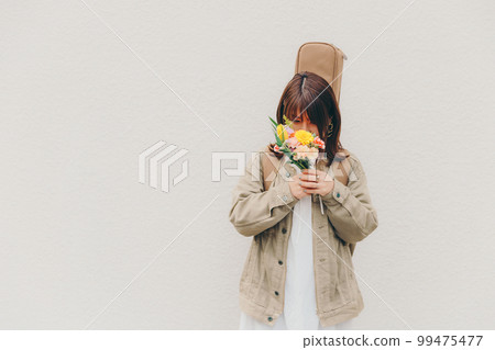 Photo of a woman with a guitar and flowers Photo of a woman with a guitar and flowers 99475477