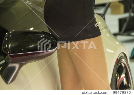 The thighs of a campaign girl model standing next to a car The thighs of a campaign girl model standing next to a car 99479870
