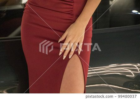 Legs peeking out of sexy slit red dress 99480037