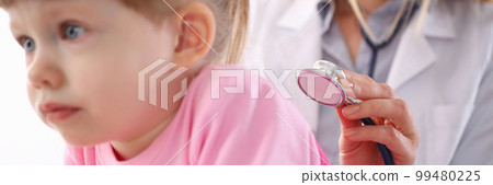 Pediatrician listens to lungs of small child girl with stethoscope 99480225